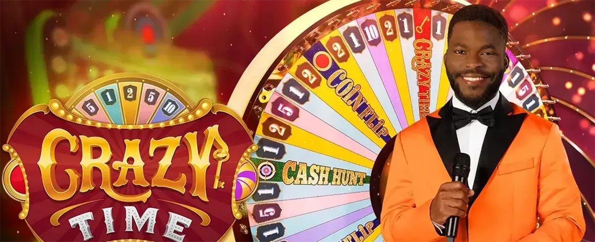 Promotional image for Crazy Time showing the large “CRAZY TIME” title beside a colourful game wheel, with a smiling male host in an orange tuxedo holding a microphone in front of the wheel.